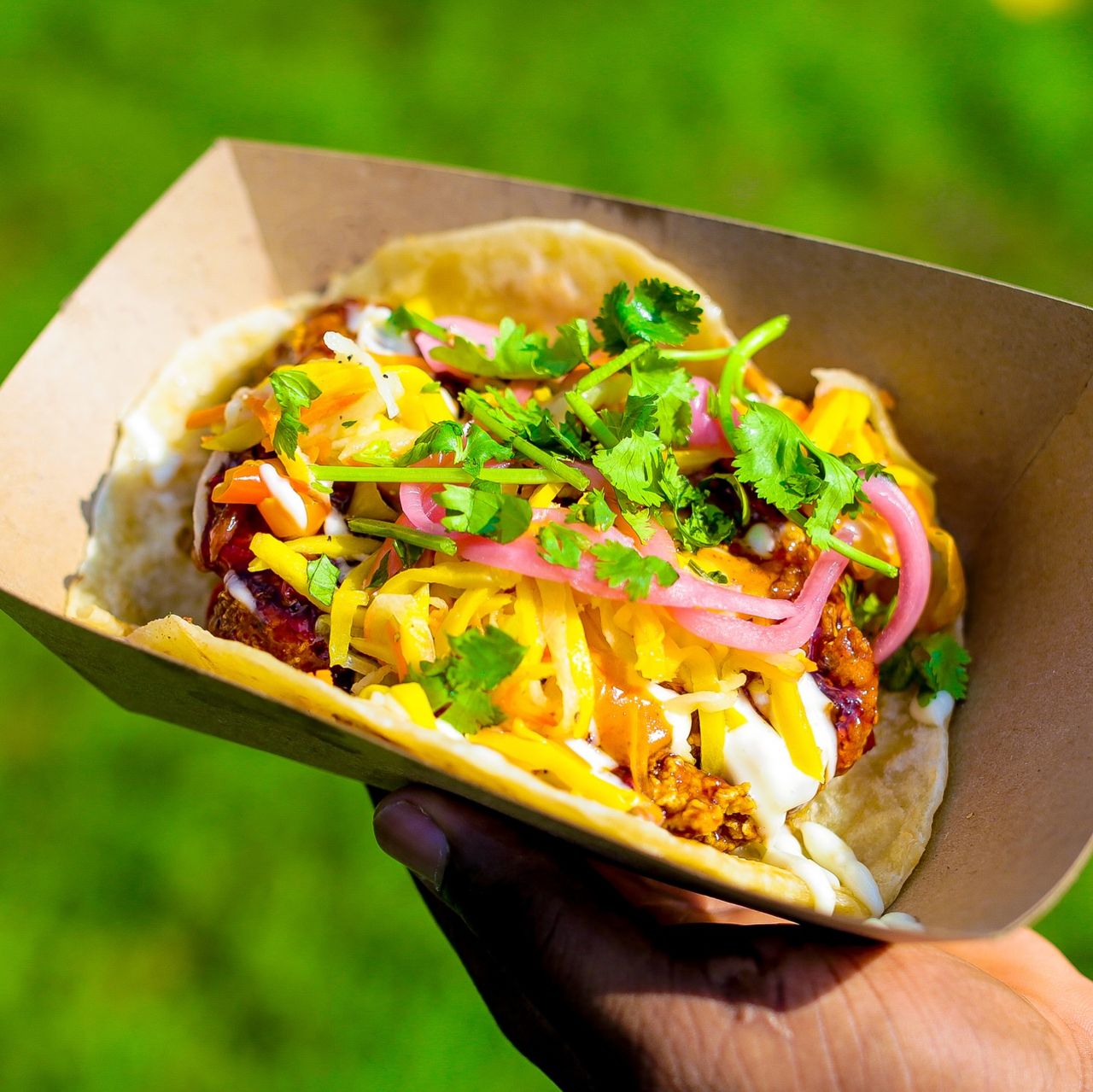 A person holds a taco at Taco Fest