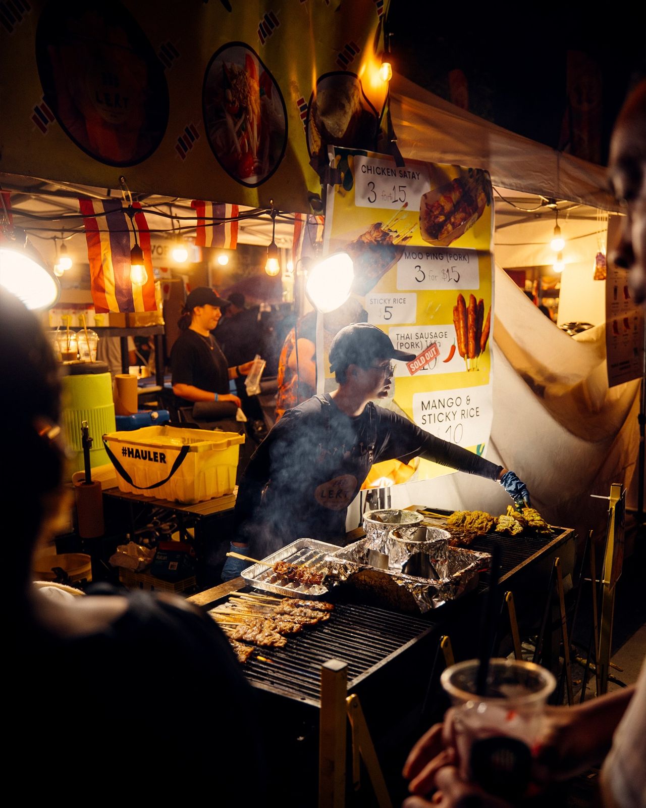A chef grills food at a night market