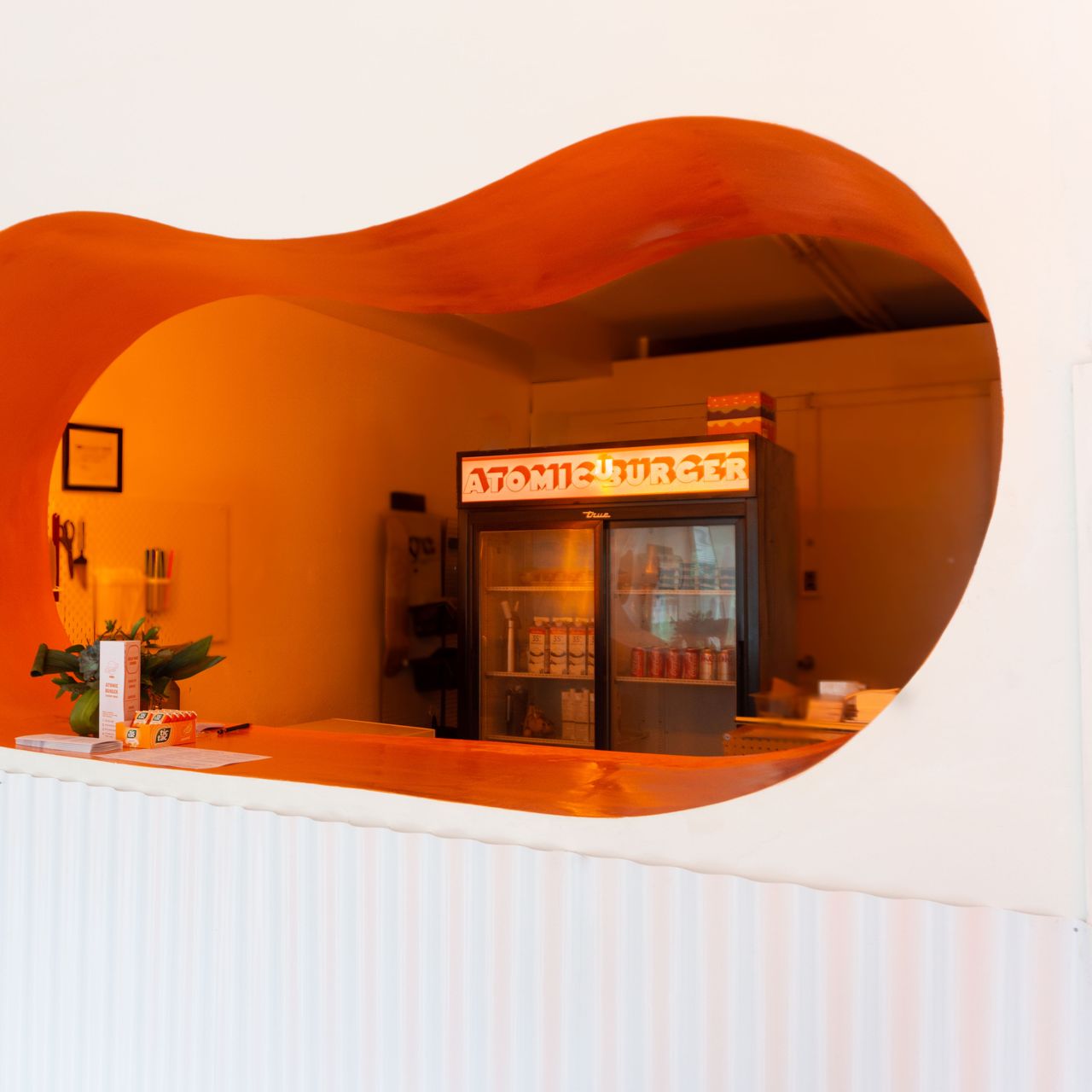 The counter at Atomic Burger, a space-themed takeout counter in Toronto