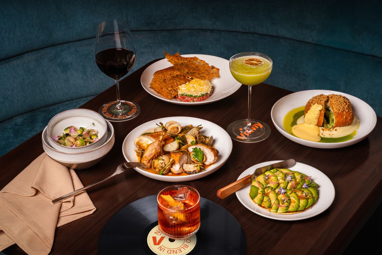 A spread of food and drinks at Vinny in Toronto