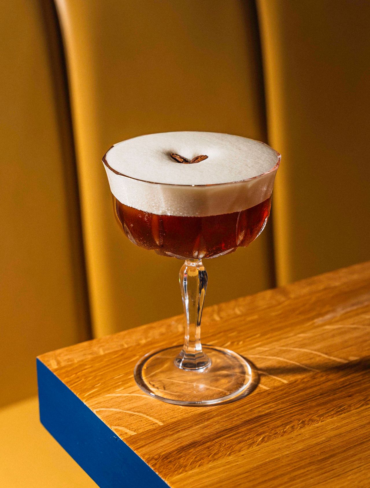 An espresso martini in a coupe glass