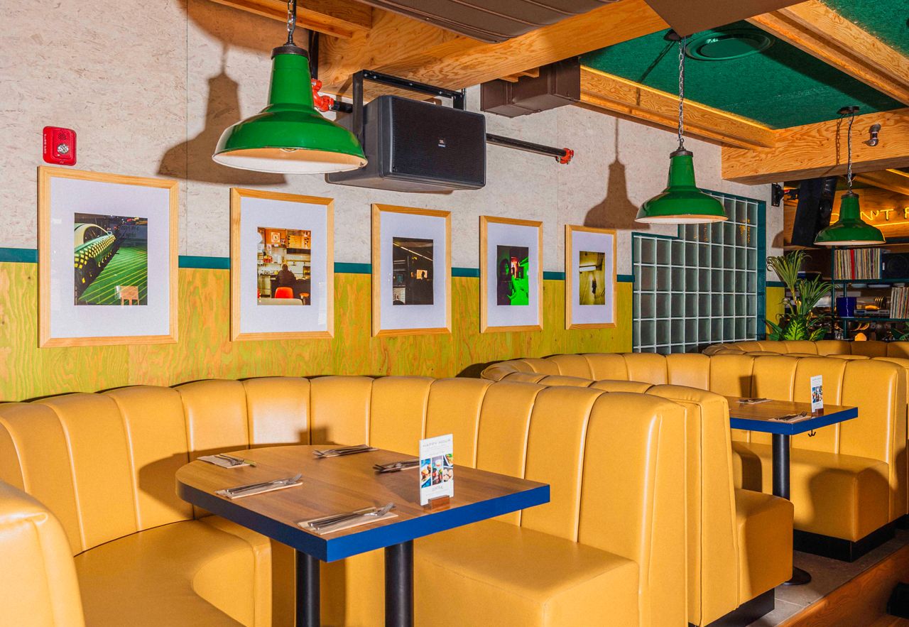 Yellow booth seating at Central, a bar and restaurant in Toronto