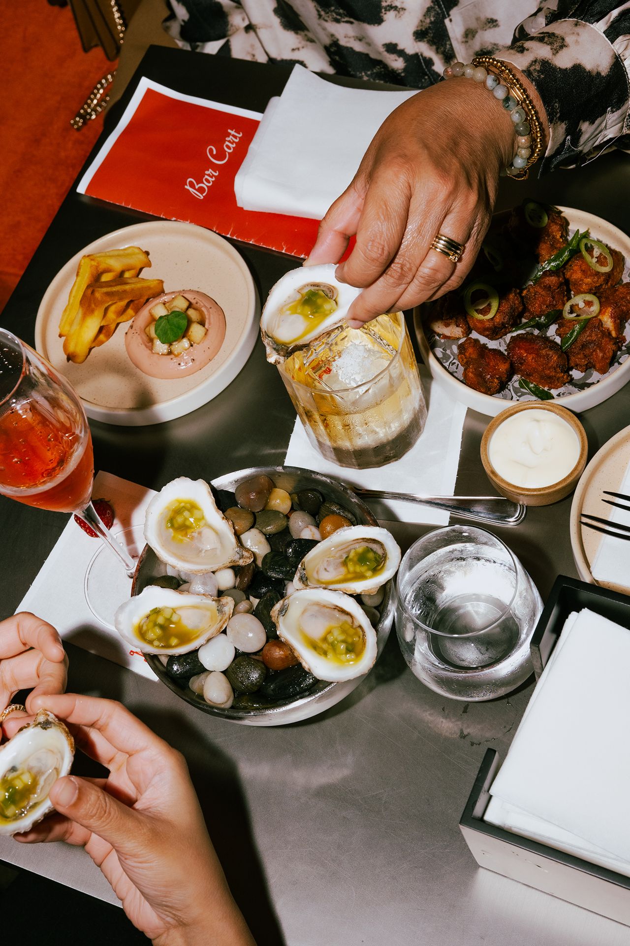 A selection of drinks and snacks at Bar Cart, a speakeasy in Toronto