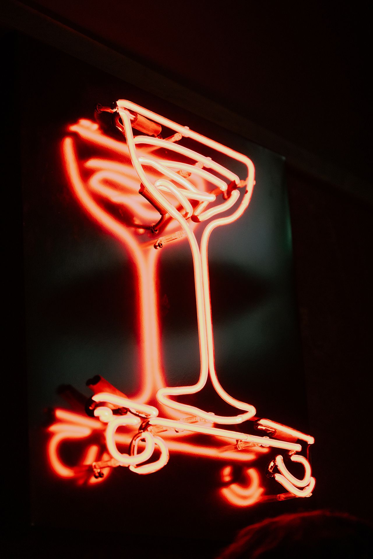 A neon sign in the shape of a coupe at Bar Cart, a cocktail lounge