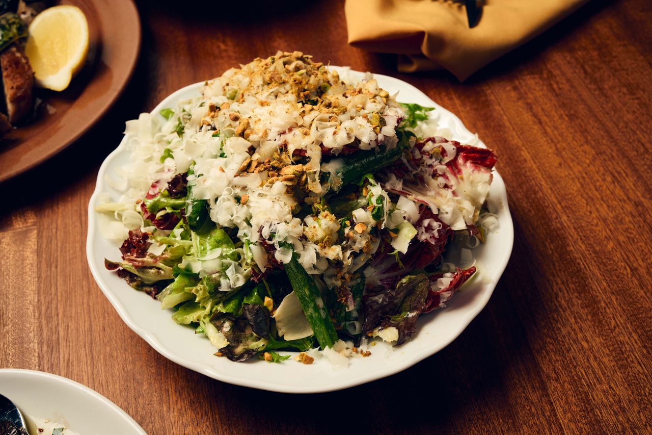 A big green salad made with a blend of local lettuces tossed in a bright roasted garlic and pistachio vinaigrette, then finished with a flurry of shaved pecorino Toscana, pickled scallions and fresh herbs