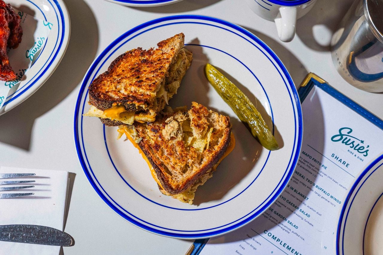 A tuna melt with a pickle spear