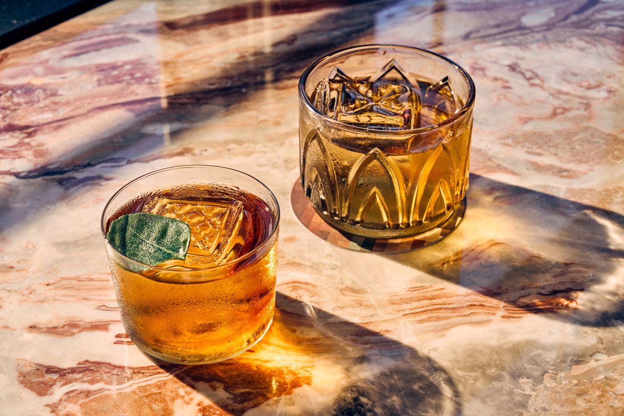 Two cocktails on a marble bar at Taberna LX in Toronto