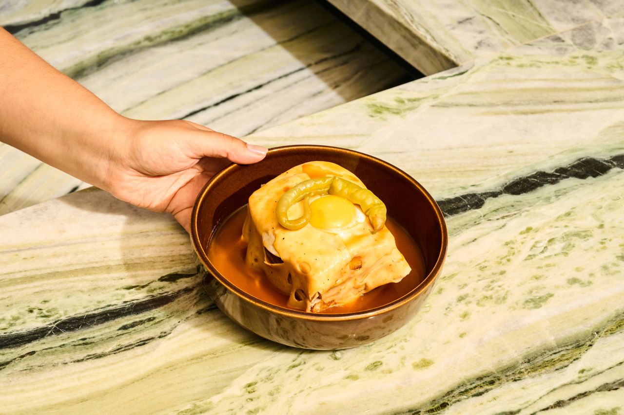 Thinly sliced sirloin, mortadella, chorizo and a fried egg arrive between two slabs of brioche for Taberna LX’s Francesinha, a take on a Croque Monsieur