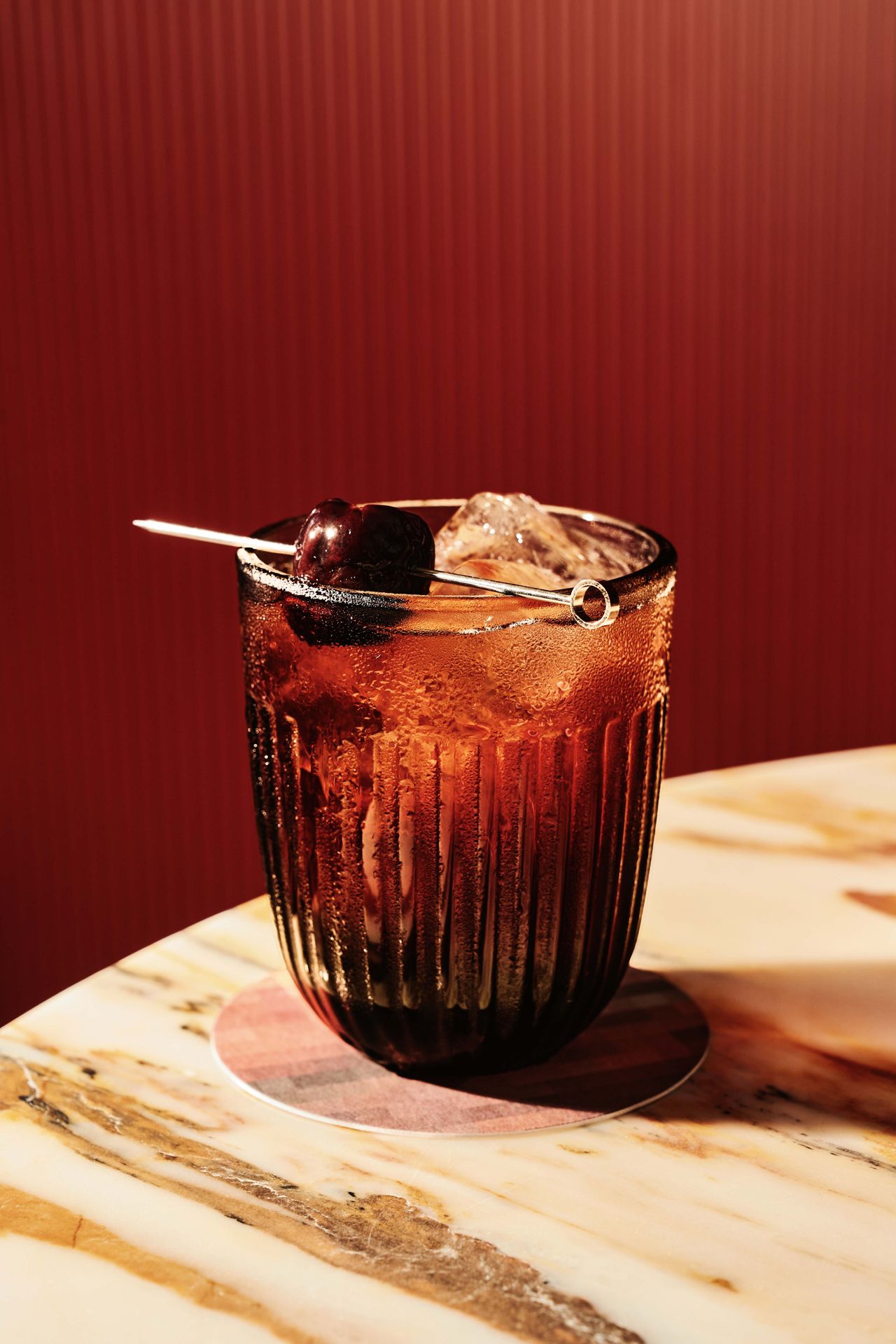 For the Porto Cola, similar to an Americano cocktail, Graham’s 10-year tawny port, Per Se and cherry cola syrup are stirred and strained then topped with a house-made spiced cherry