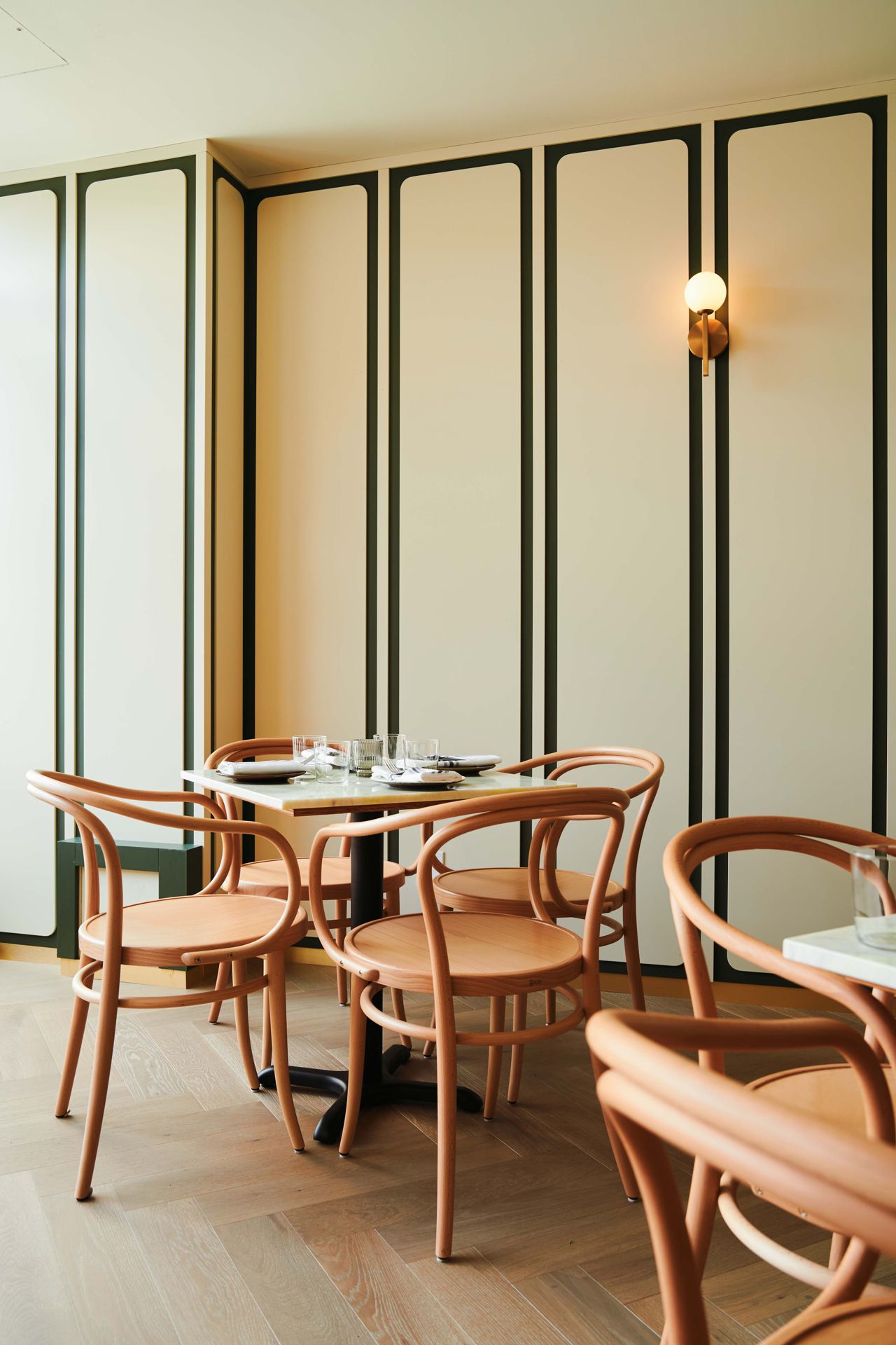 Four-top tables in the dining room of Taberna LX in Toronto