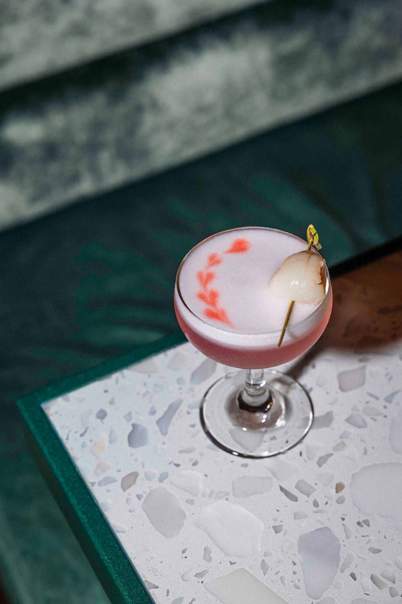 The Lychee Passion is a riff on a classic sour made with a bright blend of gin, vermouth, raspberry syrup, lemon, lychee juice and egg white