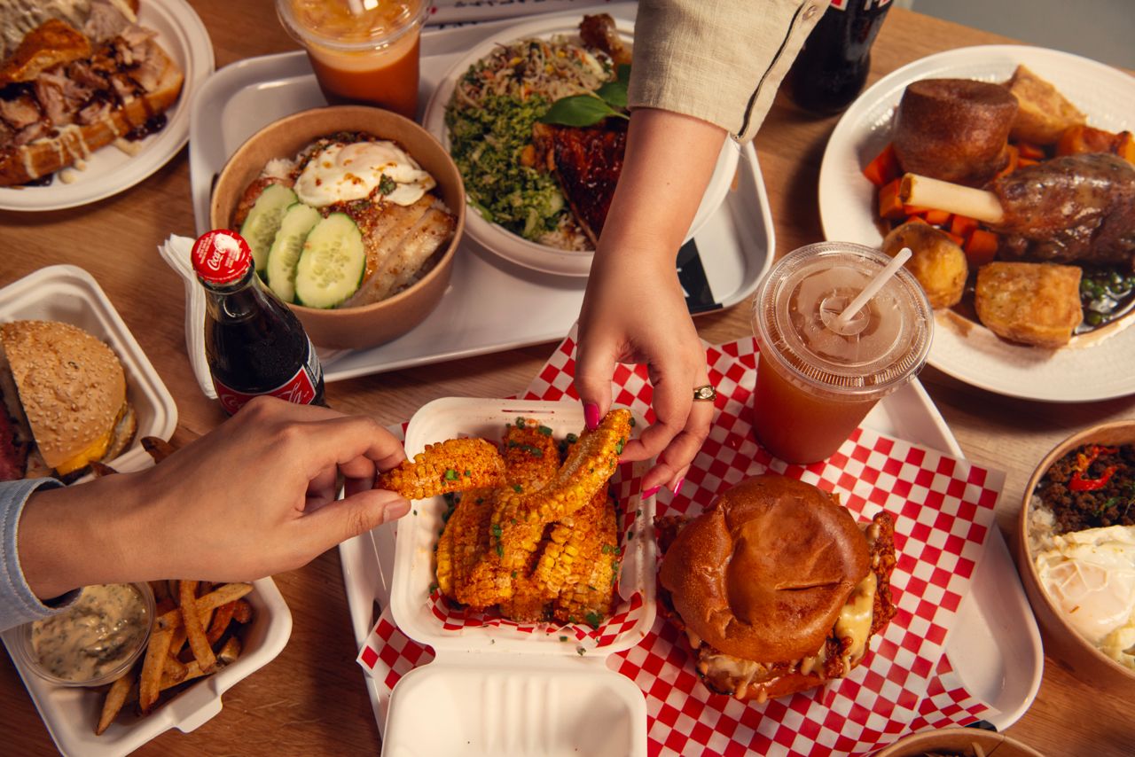 A table spread with an assortment of dishes from the food vendors inside Toronto's Wellington Market