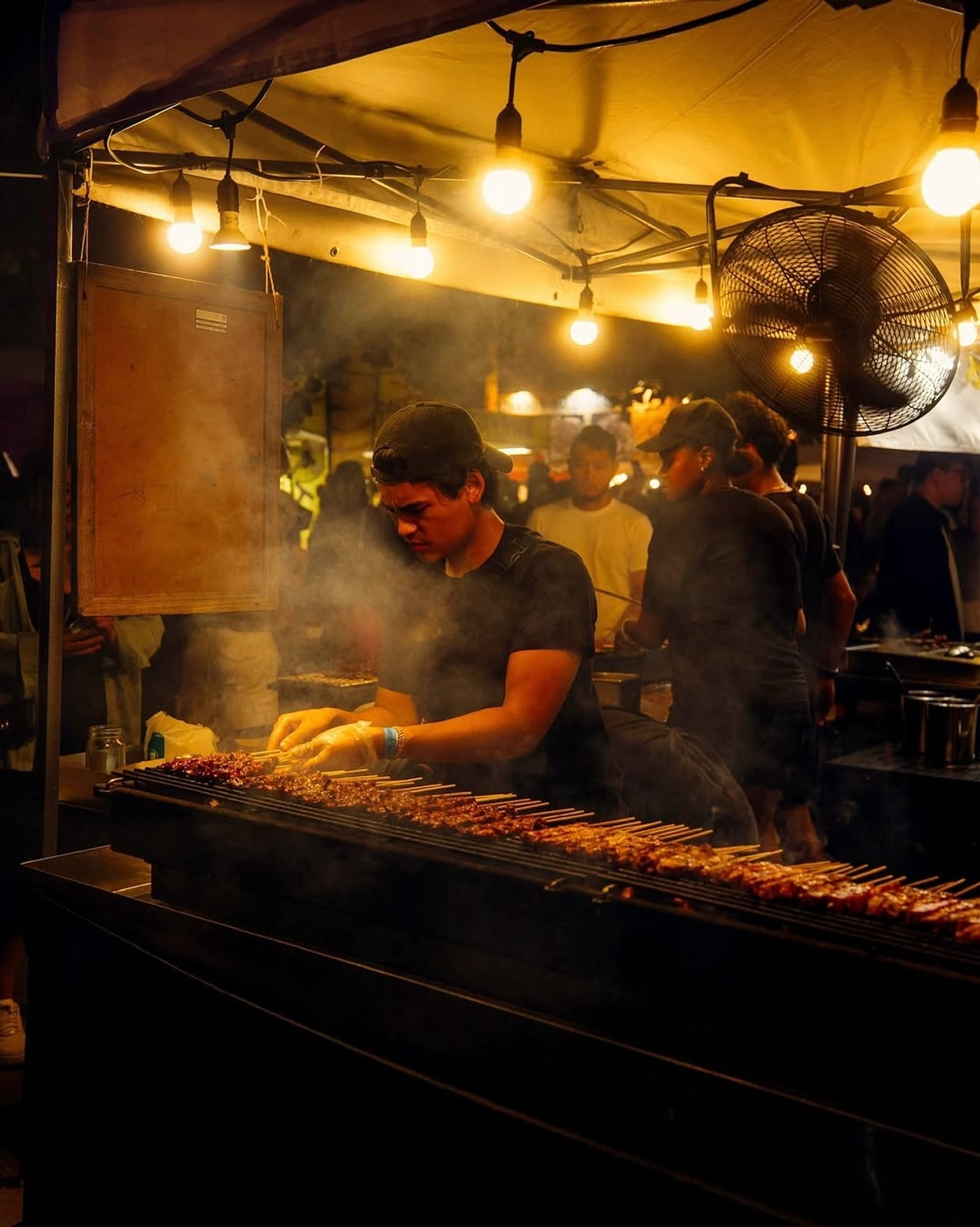 A vendor grills skewers at Toronto's Waterfront Night Market