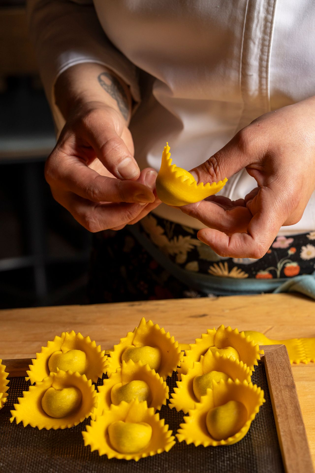A chef folds pasta at Amano