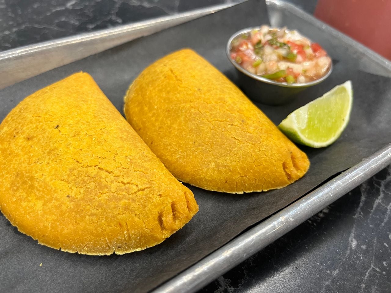 Two empanadas with pico de gallo