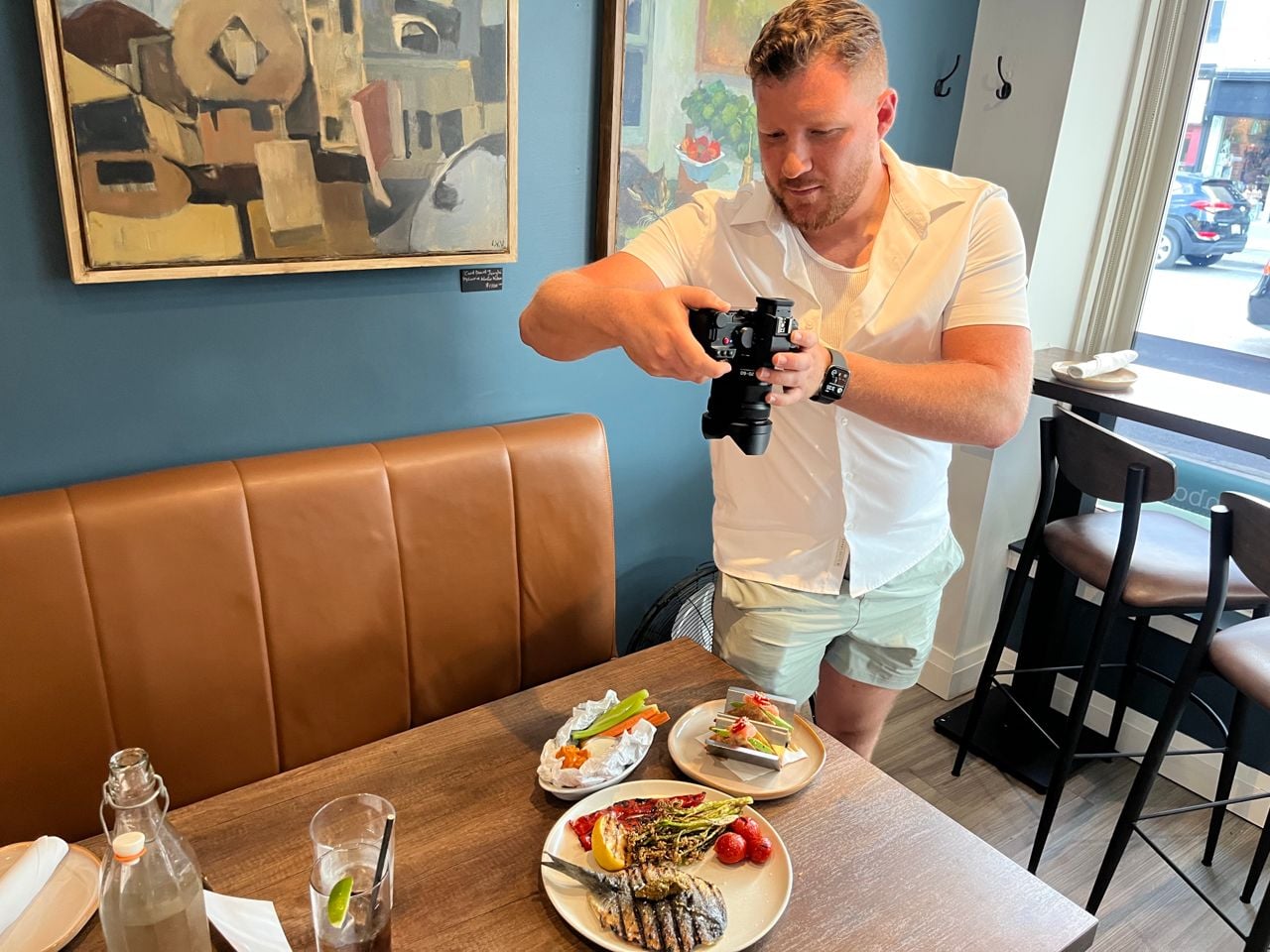 Chef Clay Smith uses a camera to take a photo of his food at Pinbones restaurant