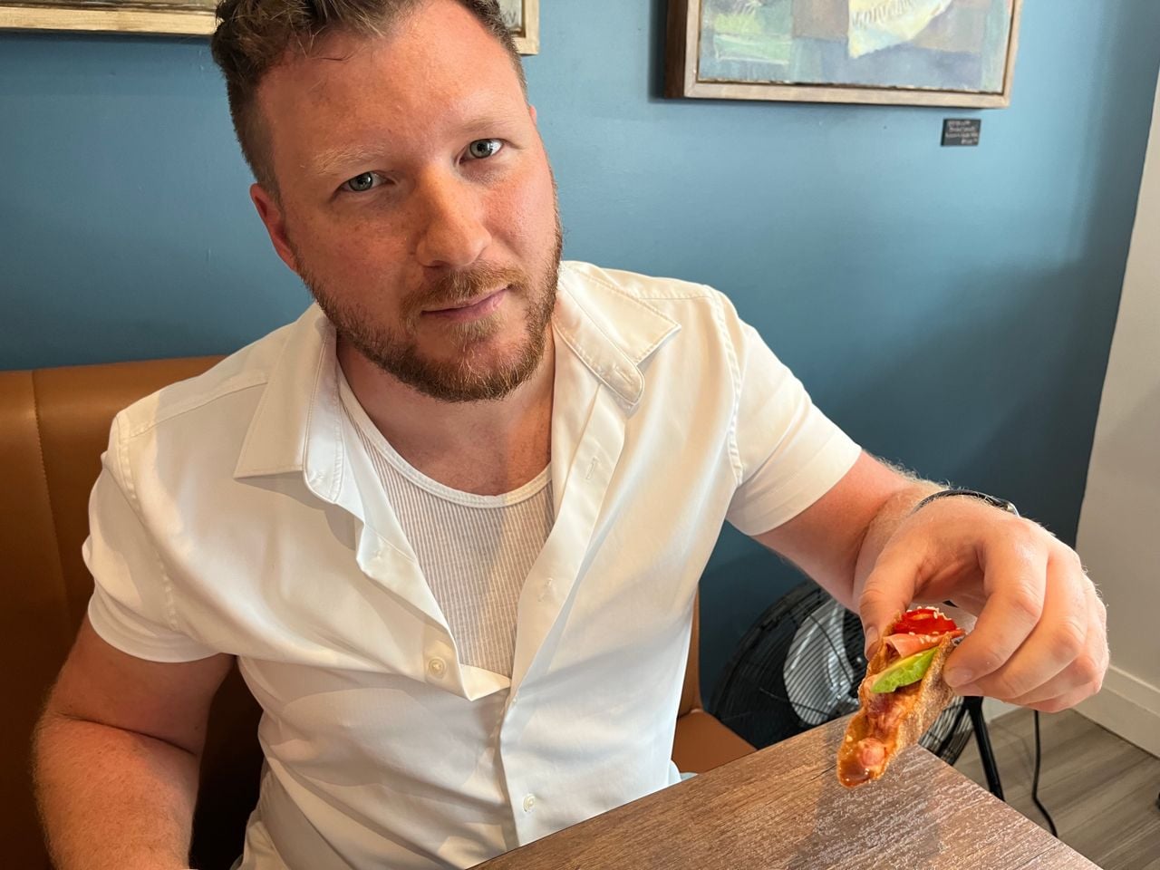 Chef Clay Smith holds up a tuna taco at Pinbones in Dundas, Ontario