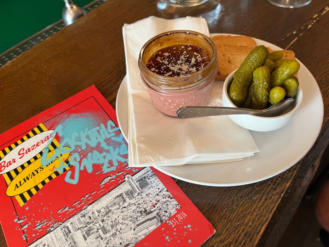An order of chicken liver paté with cornichons and crostini
