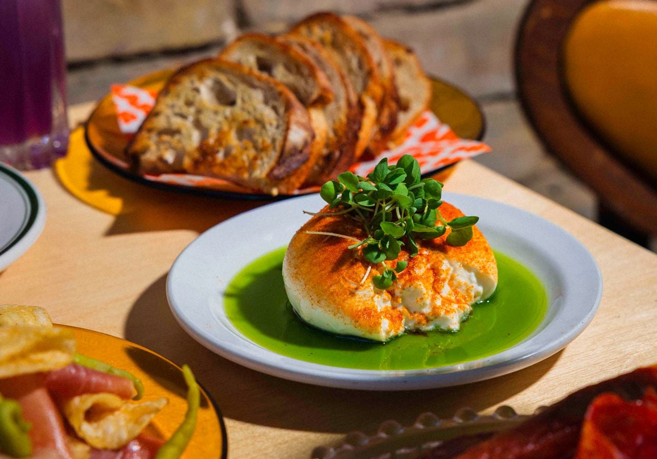 Reminiscent of a pizza, a ball of burrata imported from Italy is topped with “tomato salt” and micro-basil, in a pool of basil oil