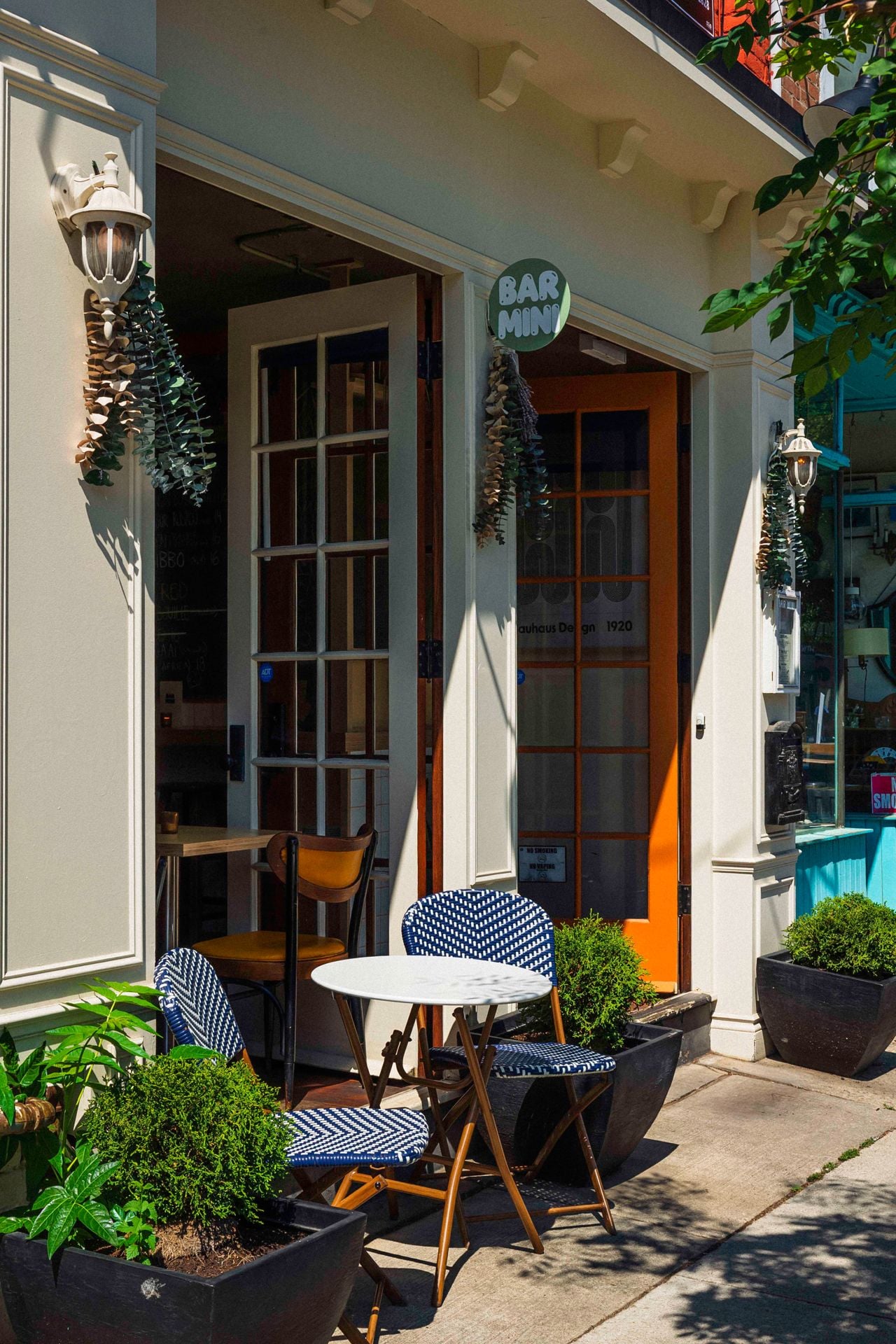The one-table patio on the sidewalk outside of Bar Mini in Leslieville