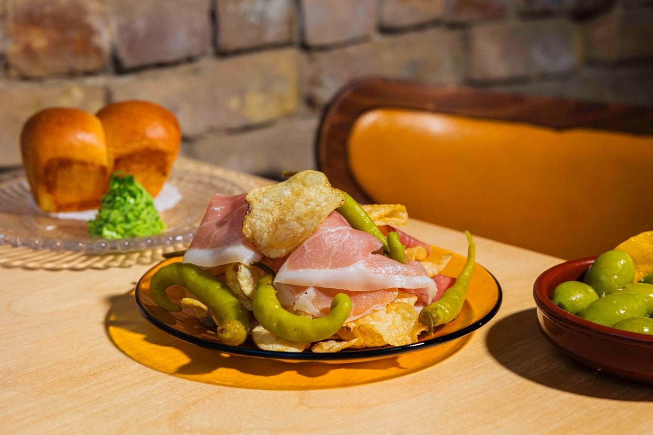 Guindilla peppers, Miss Vickie’s kettle chips and prosciutto are piled on a plate for a fatty, salty, acidic bite