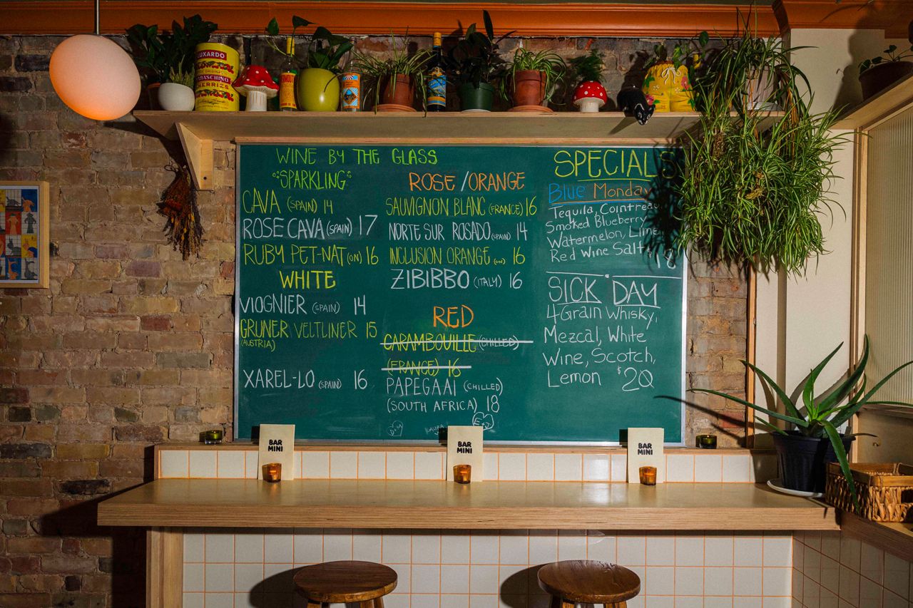 A chalkboard displays the wine list at Bar Mini