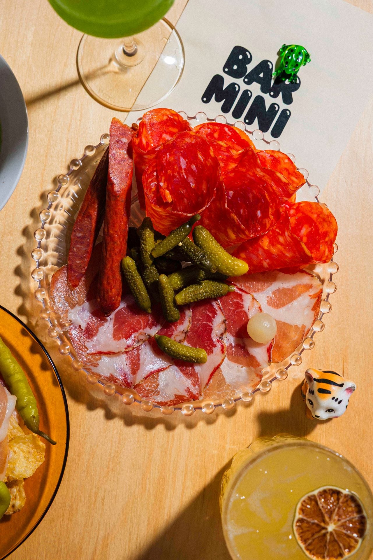 Sliced coppa, hot soppressata, Ontario pepperettes and a collection of olives and cornichons make up the salumi plate