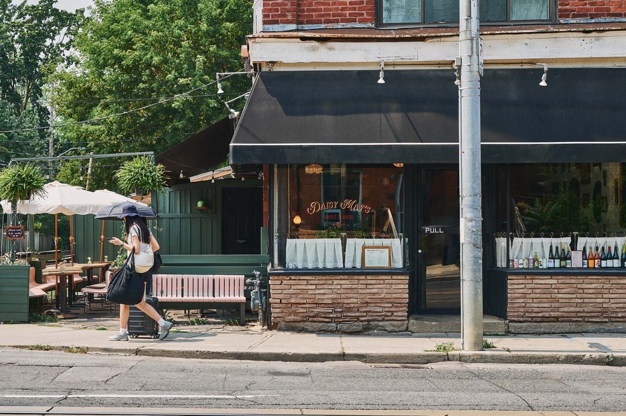 A person walks past Daisy May's, a new diner in Toronto's Annex neighbourhood