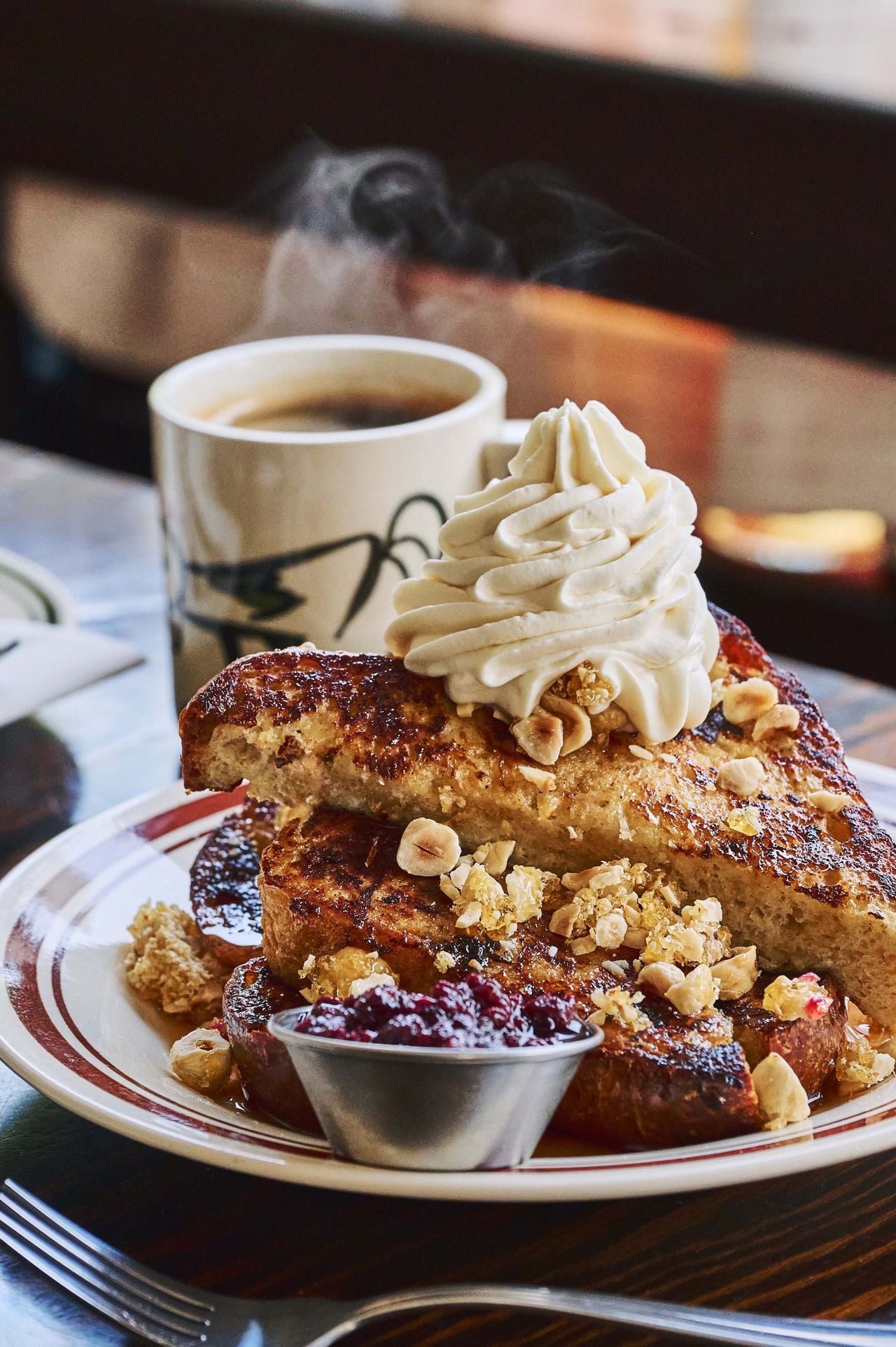 For his French toast, Gabriel dips thick slices of Ba Noi brioche into batter, then throws them on the griddle. They’re topped with a dollop of whipped creme fraiche and candied hazelnuts, drizzled with orange blossom water and maple syrup, and sprinkled with lemon zest