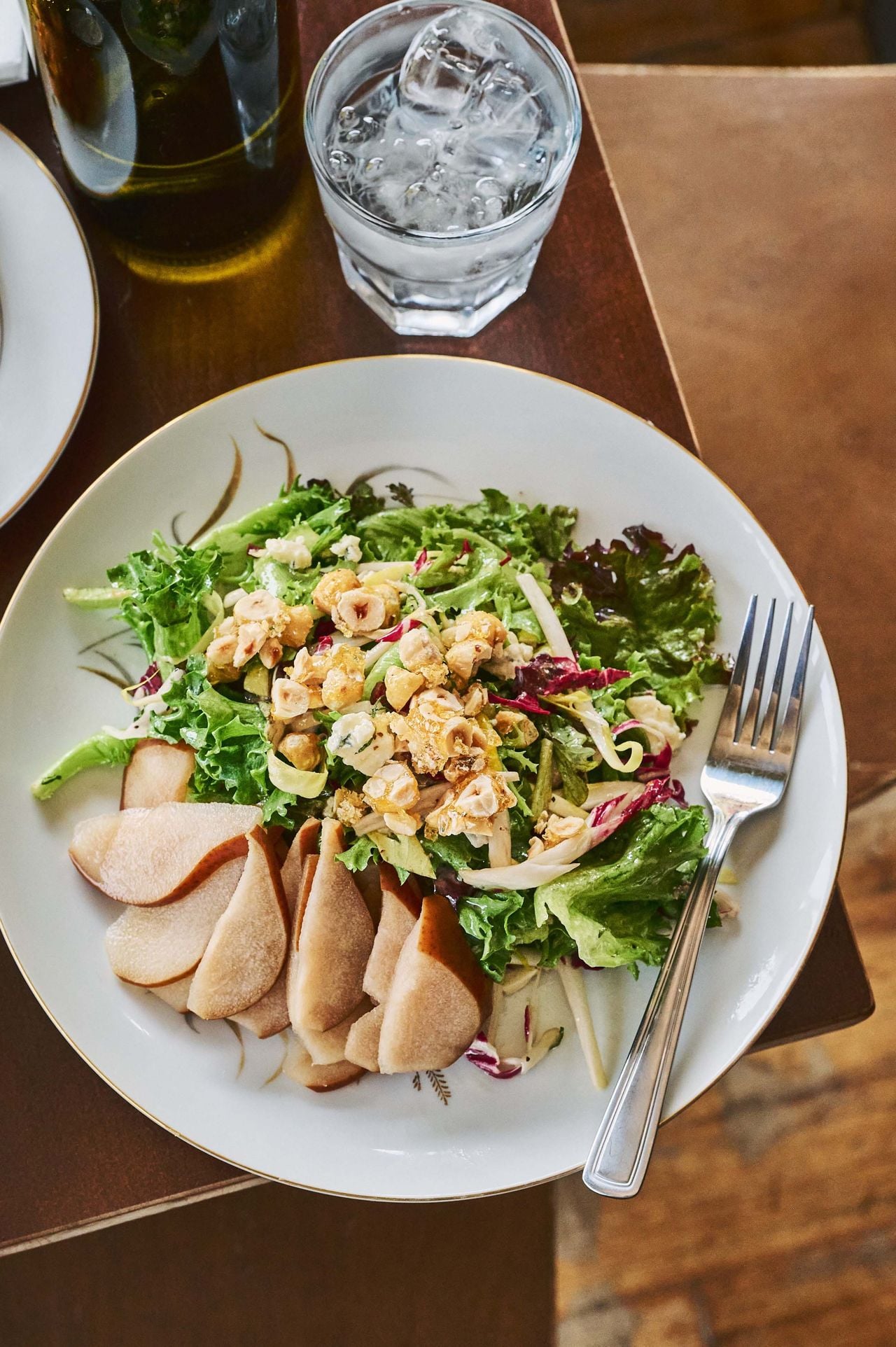 This salad is a bittersweet-and-salty medley of red leaf lettuce, Belgian endive, radicchio, and pears poached in sugar, champagne vinegar and cloves. It’s finished with funky gorgonzola, fresh mint and candied hazelnuts