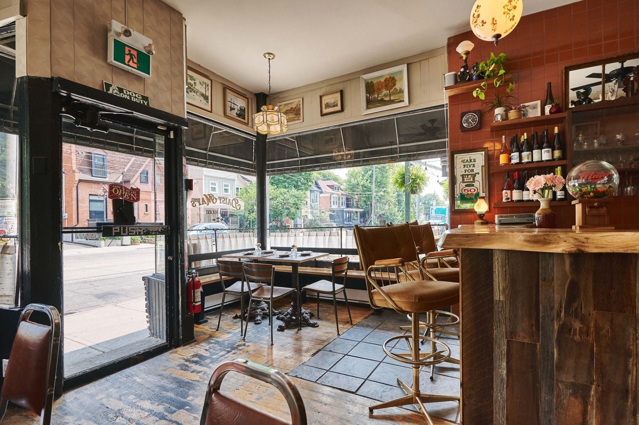 The dining room at Daisy May's, with windows looking out to Bathurst Street