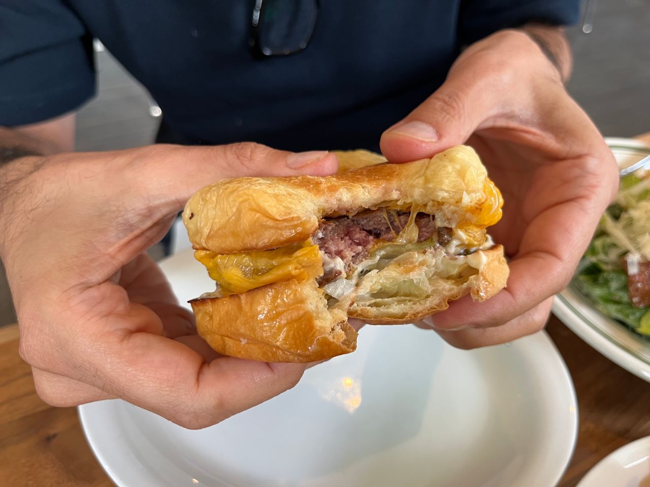 A cheeseburger with a bite taken out of it