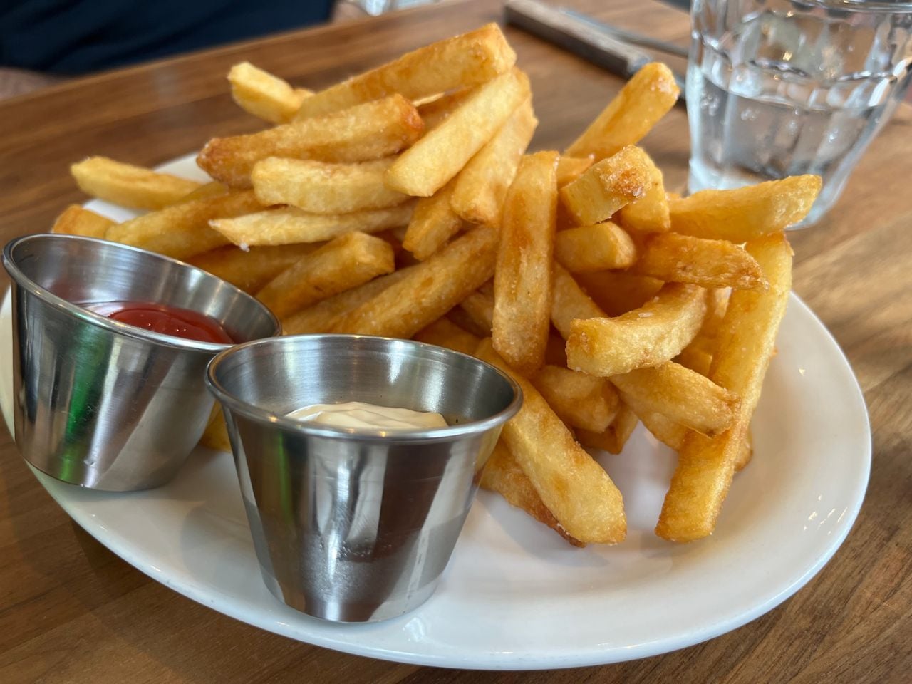 A plate of fries with ketchup and mayo for dipping