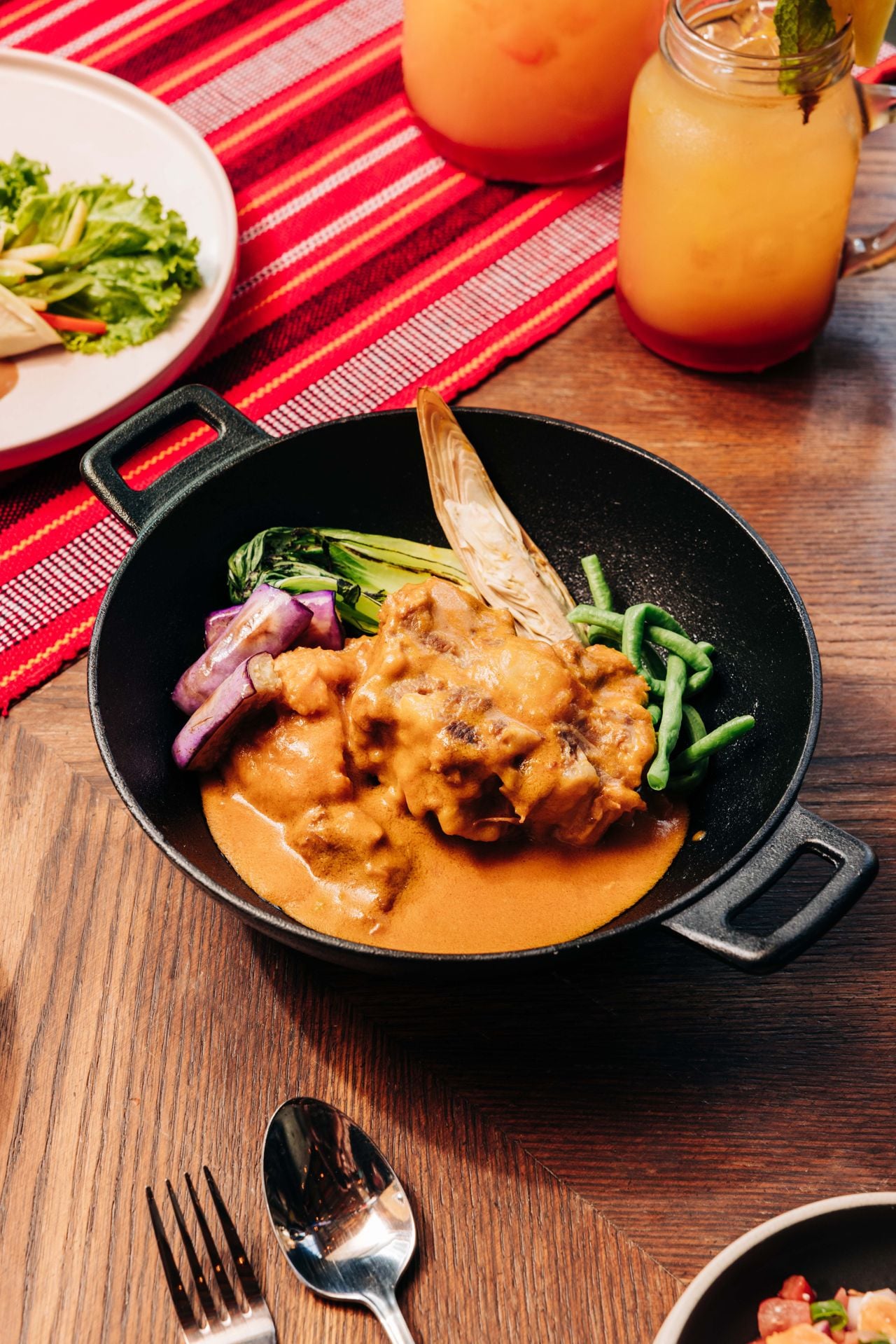 Makilala’s kare-kare stars fall-apart oxtail in a lush peanut stew, ringed with bok choy, eggplant, banana blossom and green beans