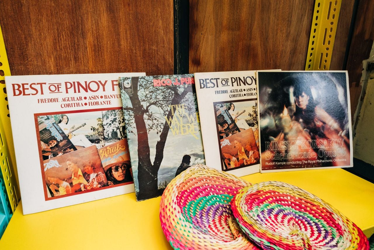 Filipino records and fans on a shelf at Makilala