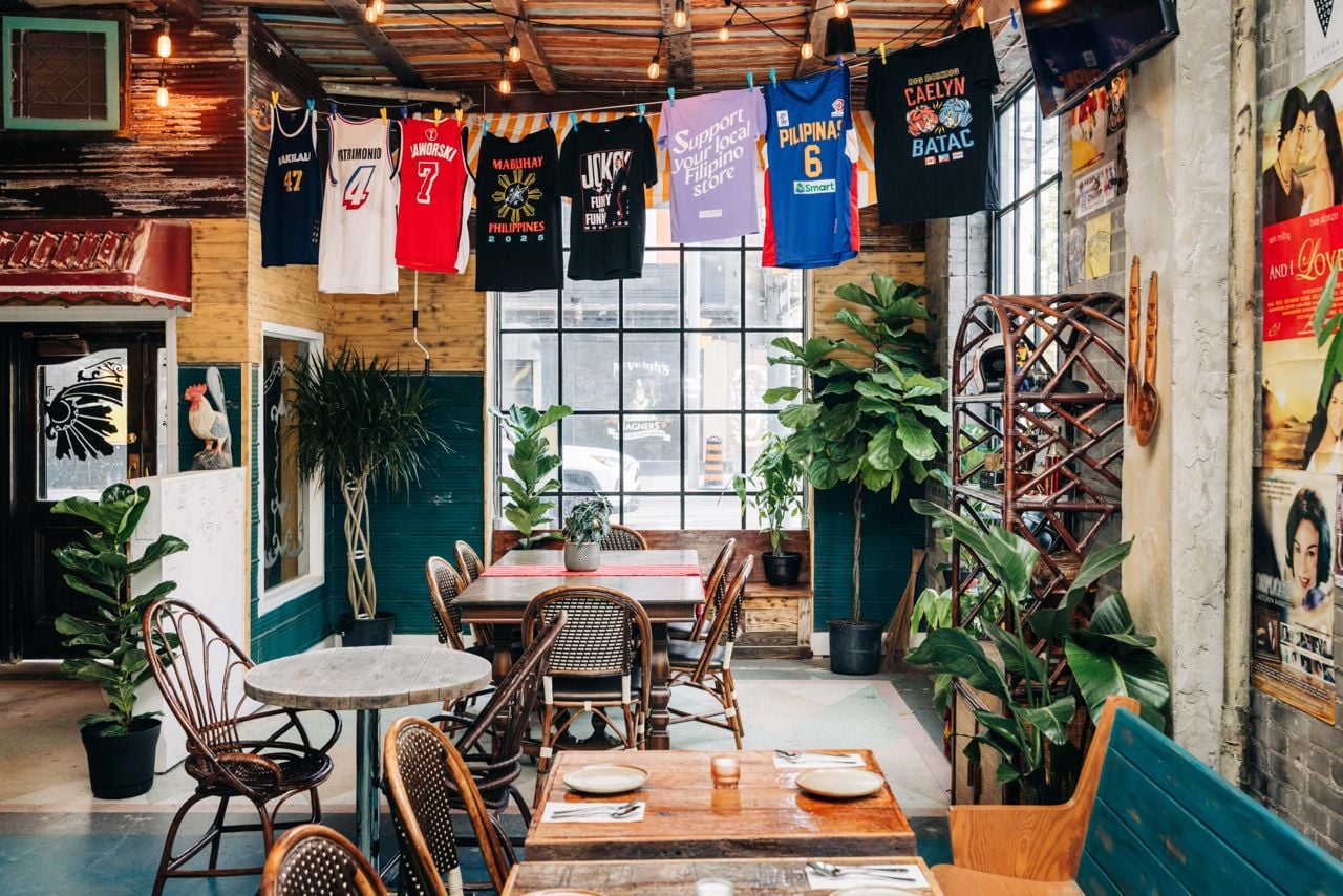 Sports jerseys and t-shirts hang on a line above the dining room at Makilala