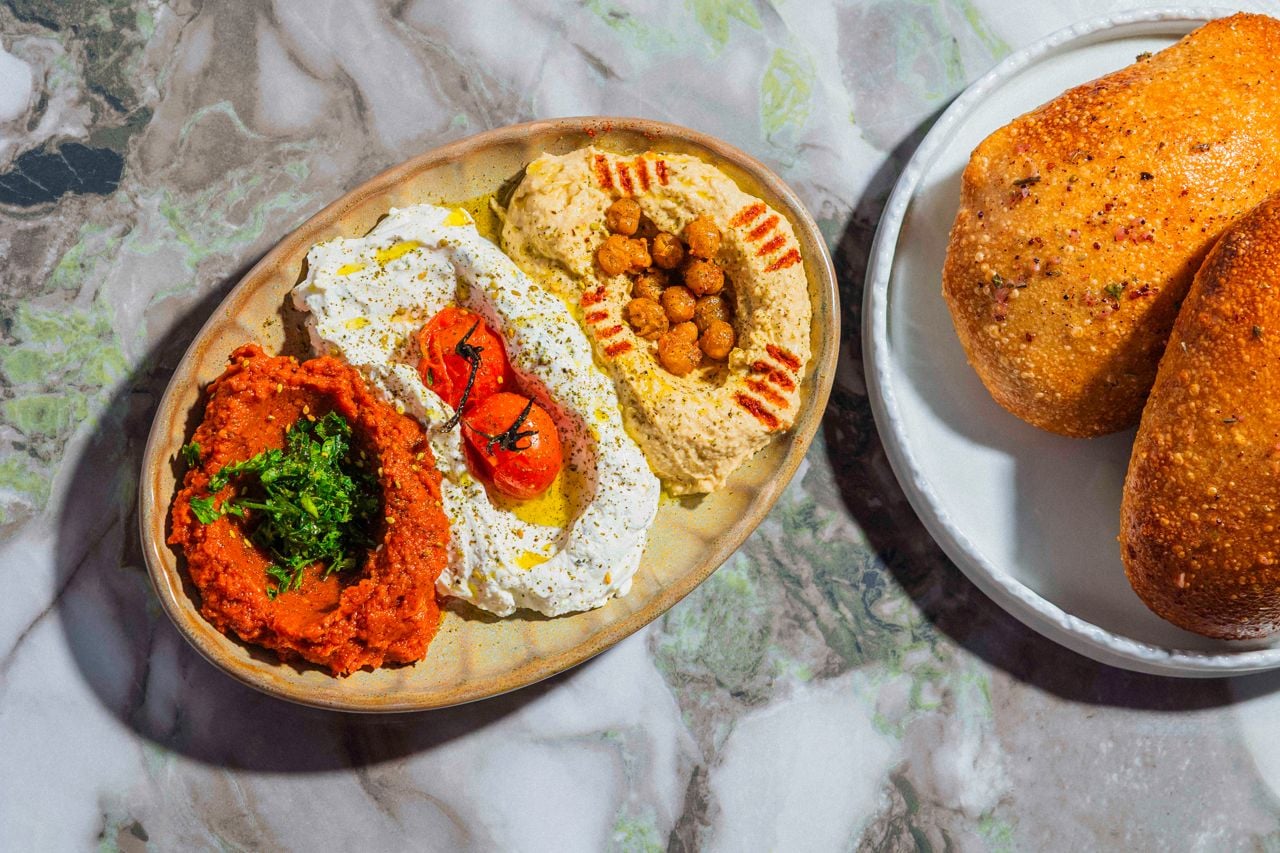 Hummus, labneh and muhammara served with puffed pita
