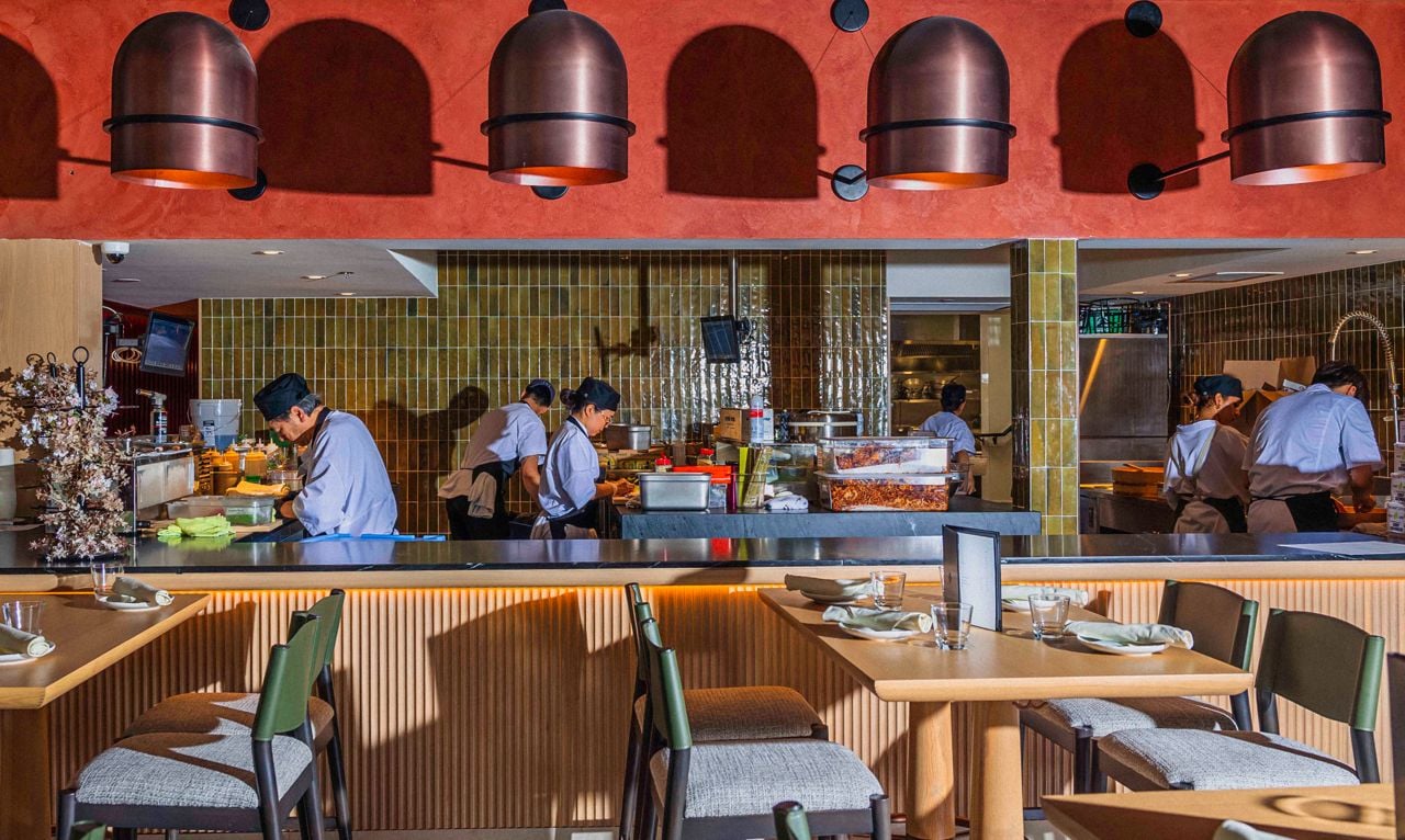 Chefs work in an open kitchen at Queens Harbour