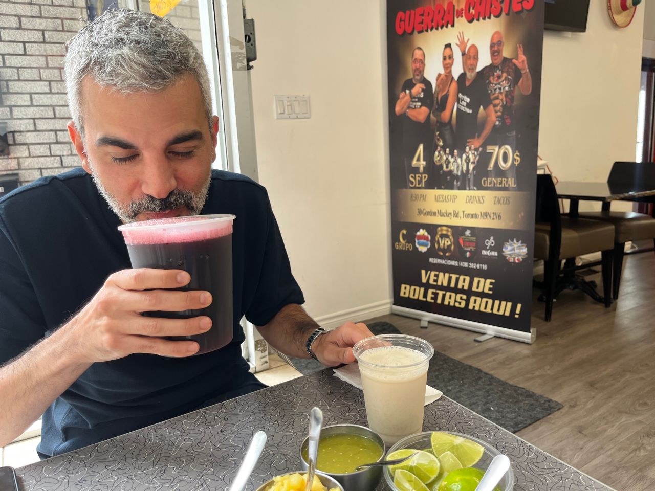 Philip Haddad holds a container of jamaica at Taqueria El Pastorcito in Toronto