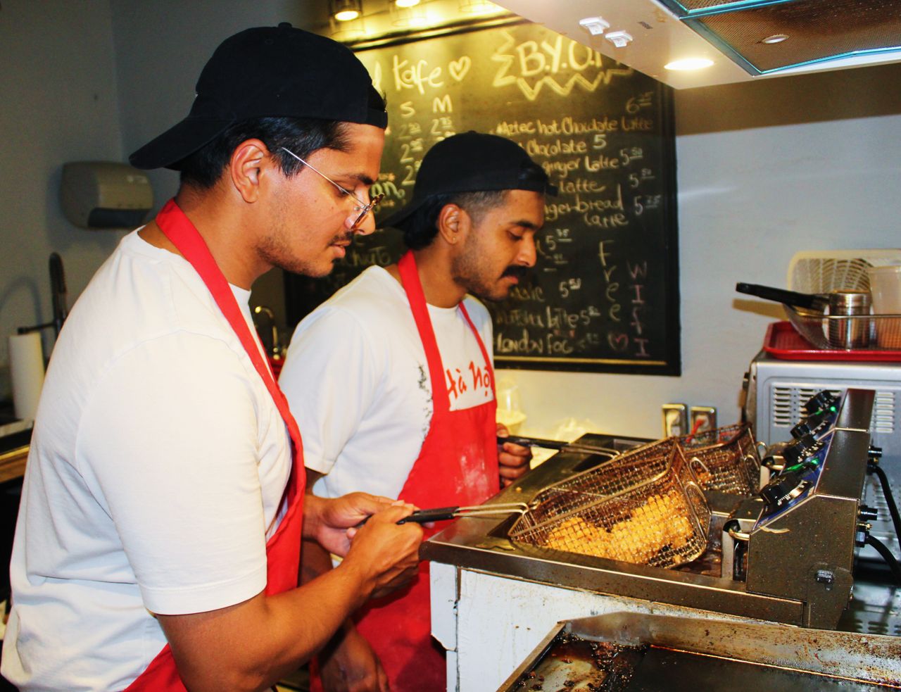 The chef-owners at Those Guys, a takeout spot, take chicken from the deep-fryer