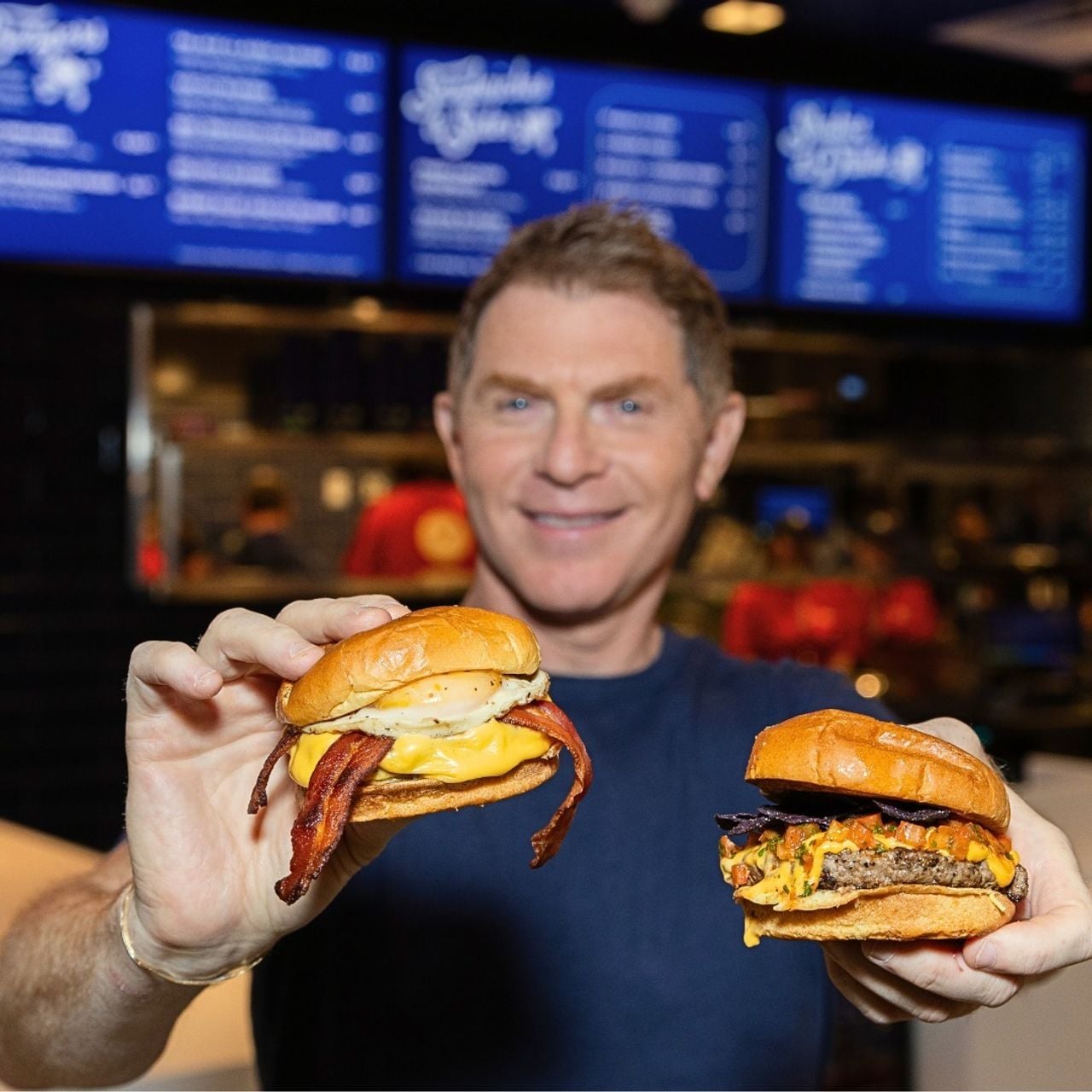 Bobby Flay with two burgers