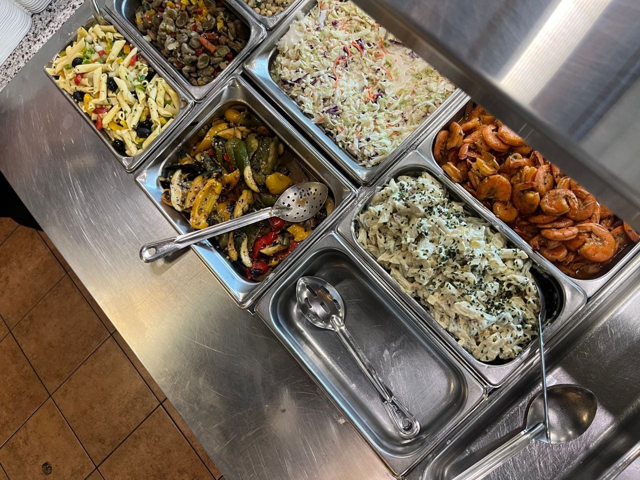 Chafing dishes full of sides at a Portuguese restaurant
