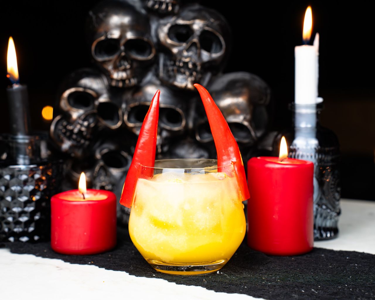 A cocktail with pepper garnishes made to look like devil horns