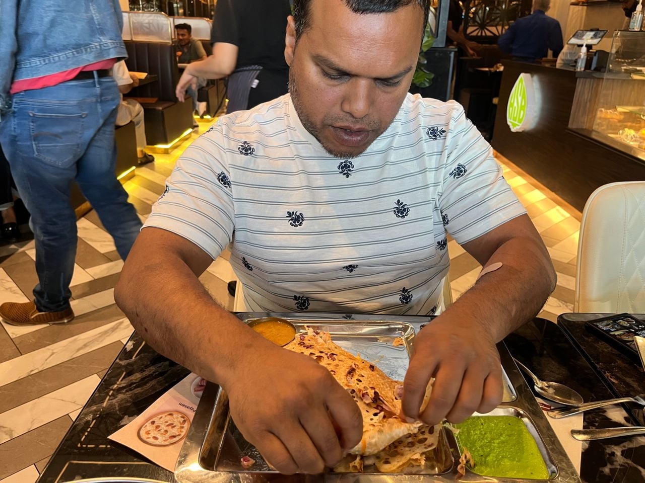 Chef Donnie Gomes folds up a dosa