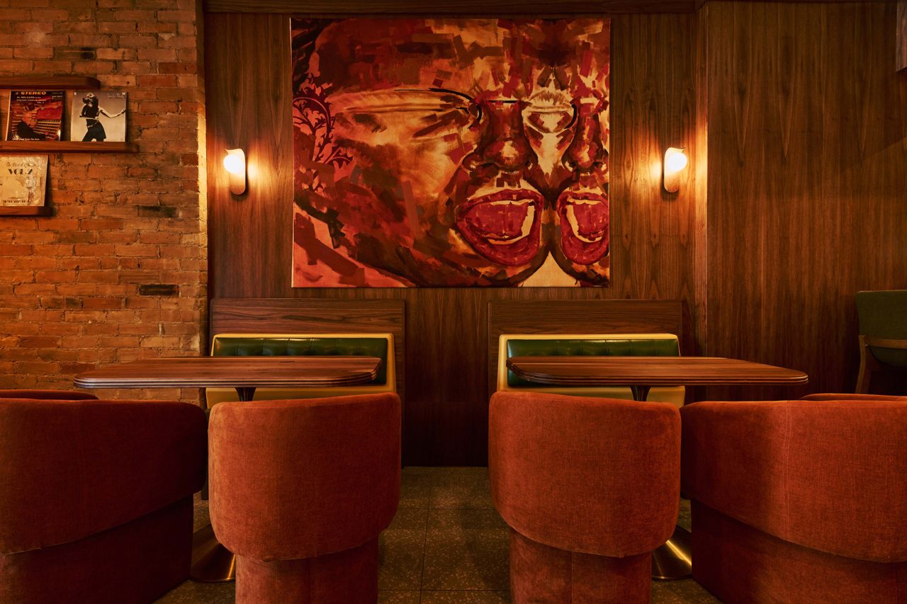 Vintage seating, artwork and lots of wood panelling in the dining room of Lonely Diner