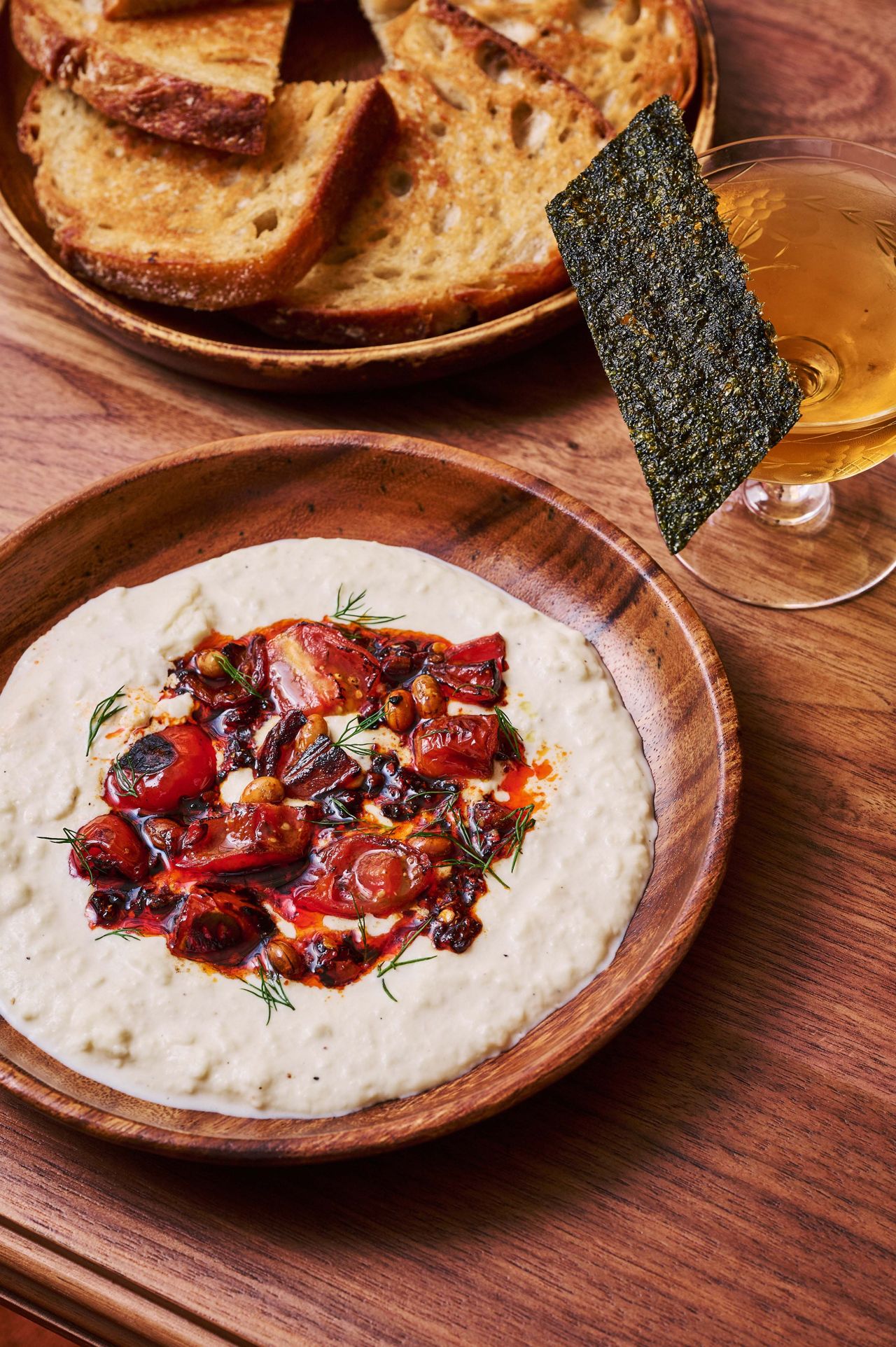 Creamy stracciatella with chili crisp–confit tomatoes and crostini
