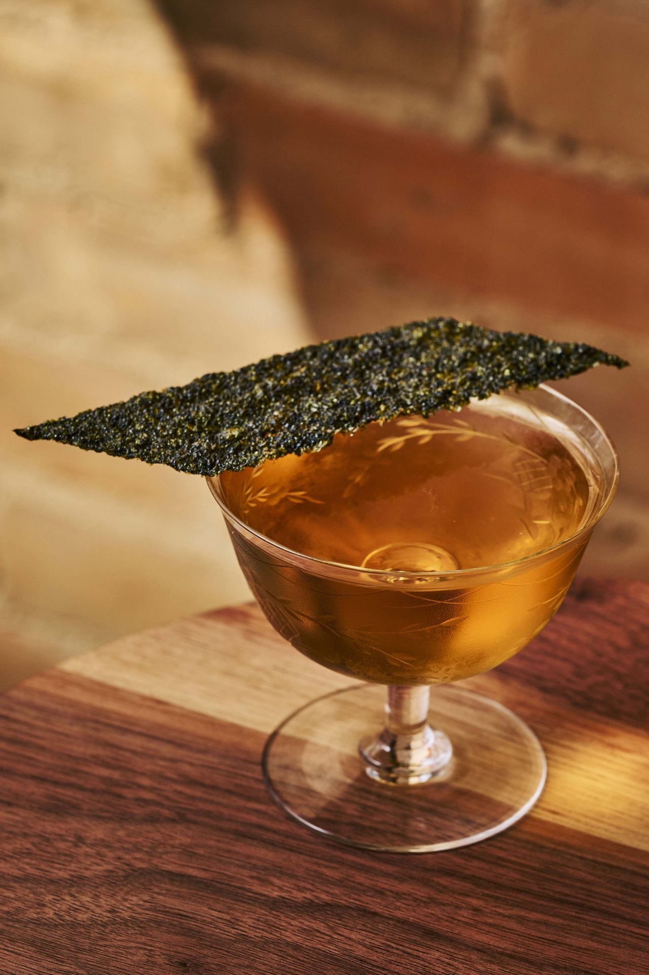 The Umami Martini, served in a coupe and garnished with a sheet of seaweed
