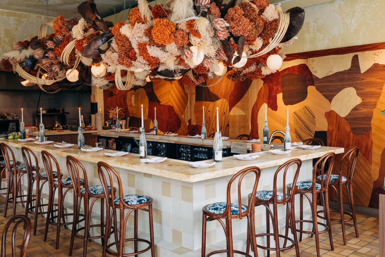 The bar at Antylia, over which dried flowers hang
