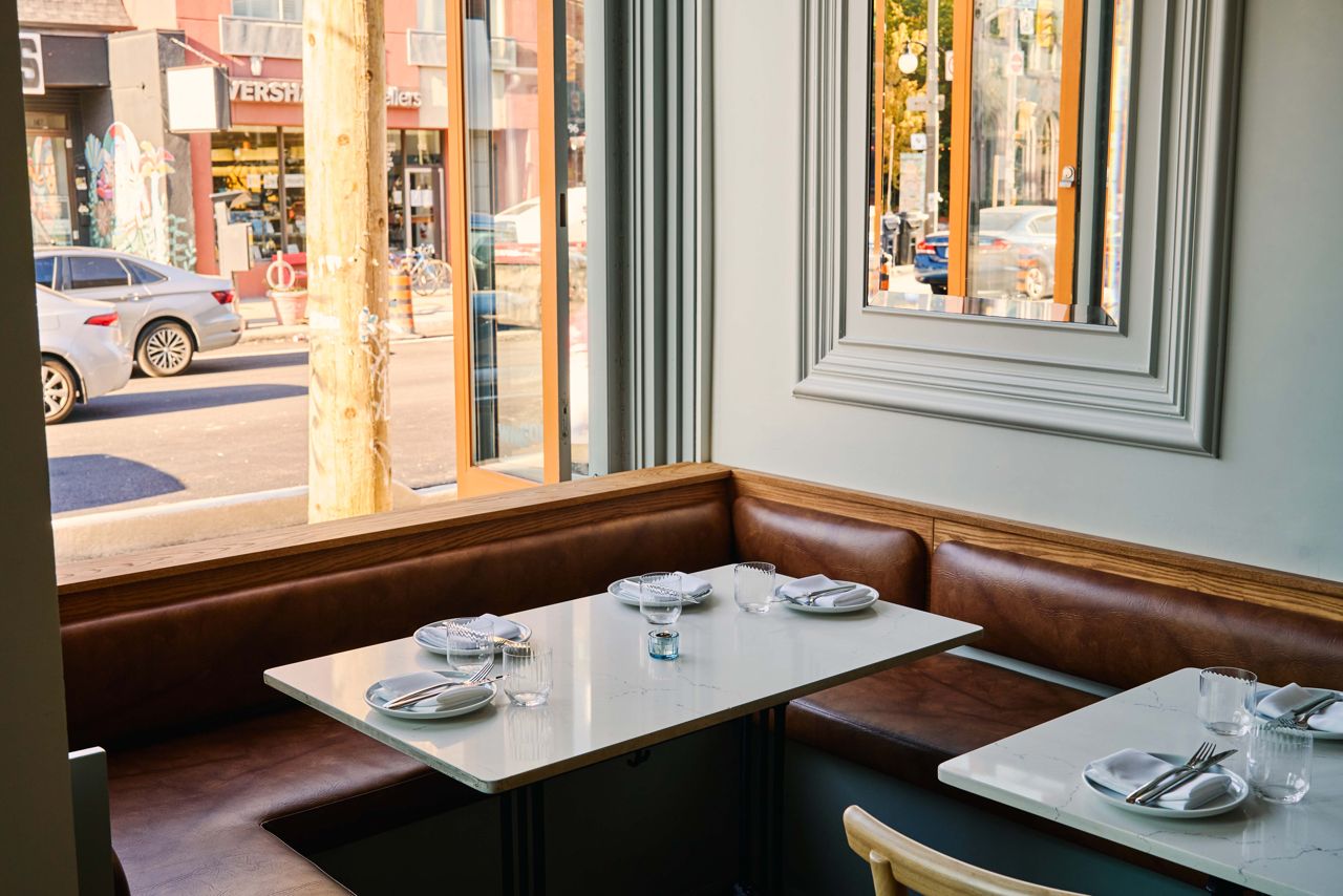 A corner table by the street-facing window at Bar Eugenie