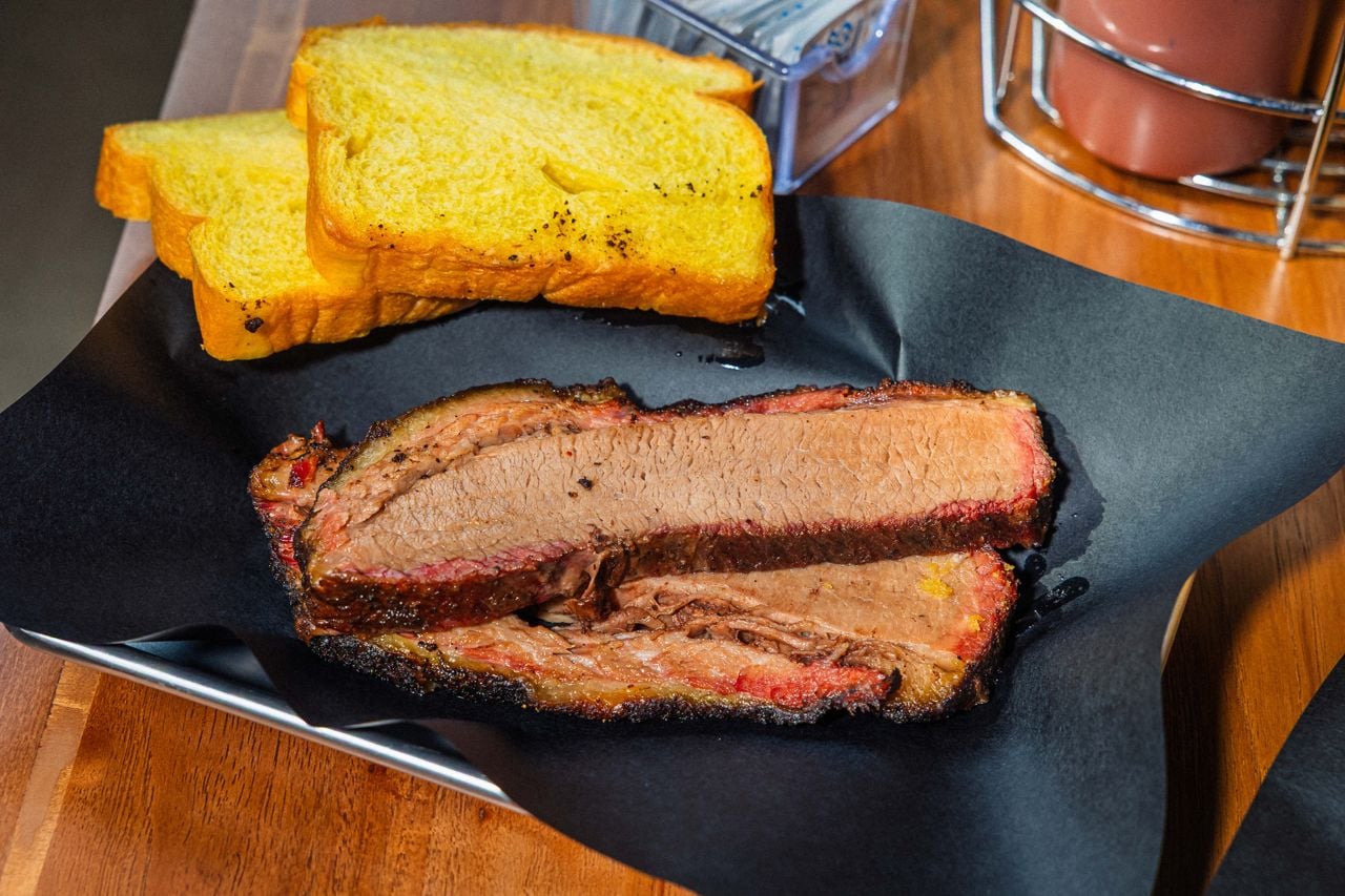 Slices of brisket with a side of bread